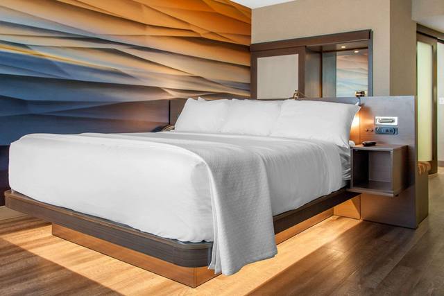 Premium bedding, desk, laptop workspace