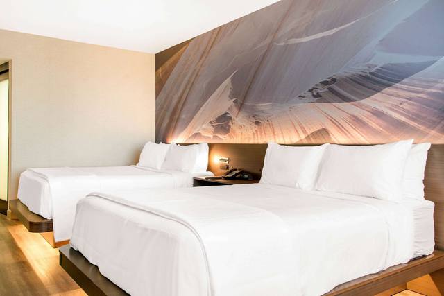 Premium bedding, desk, laptop workspace