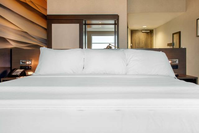 Premium bedding, desk, laptop workspace