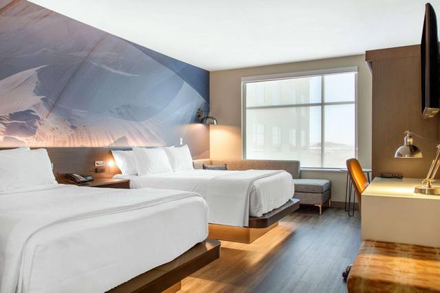 Premium bedding, desk, laptop workspace