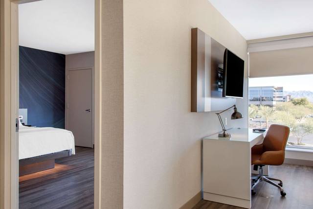 Premium bedding, desk, laptop workspace