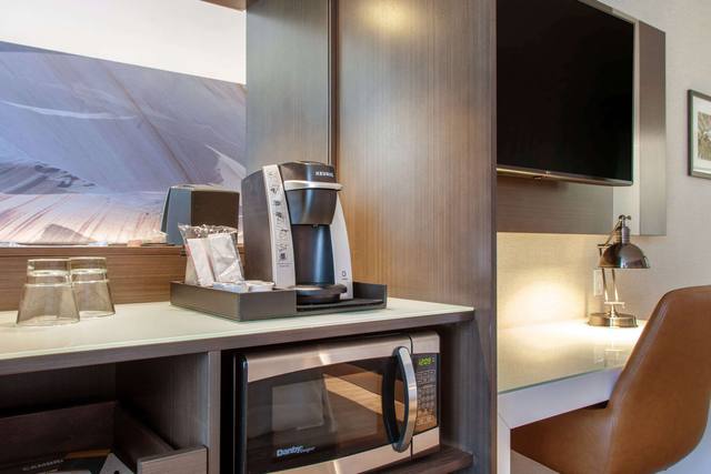 Premium bedding, desk, laptop workspace, blackout drapes