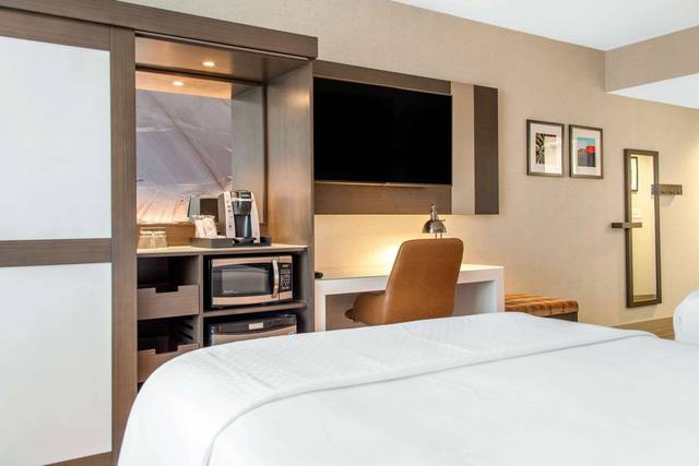 Premium bedding, desk, laptop workspace