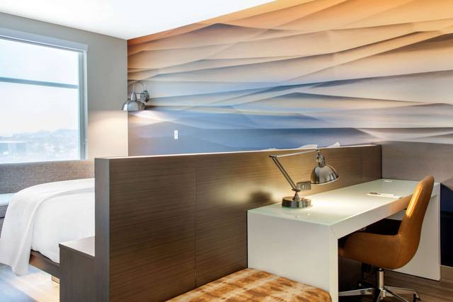 Premium bedding, desk, laptop workspace
